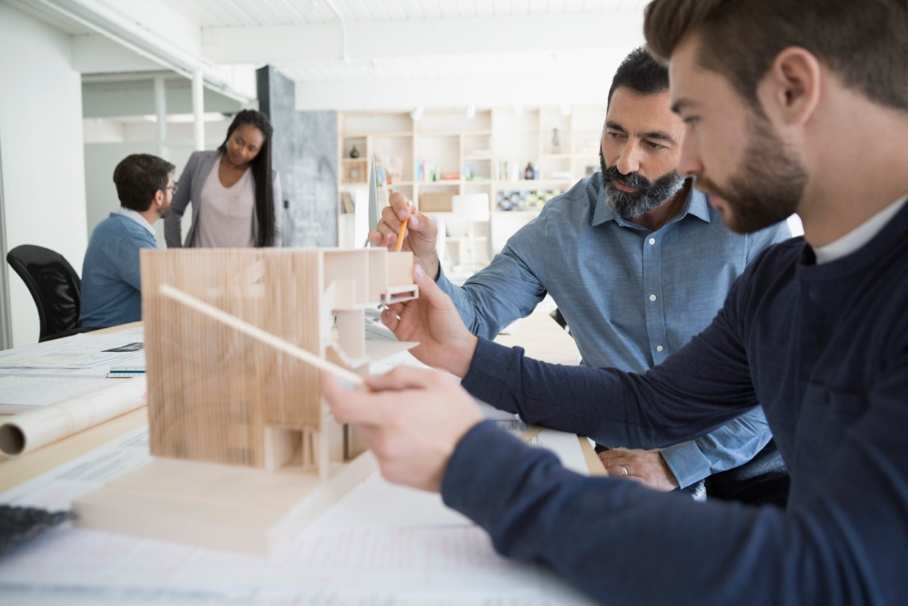 two-male-architects-working-on-a-building-model.jpg