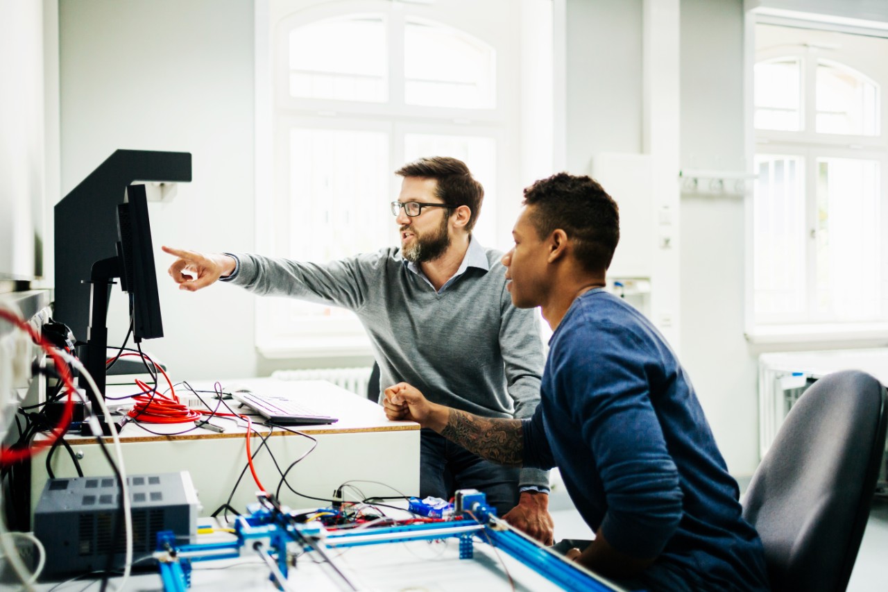 Engineers collaborating at a computer workstation